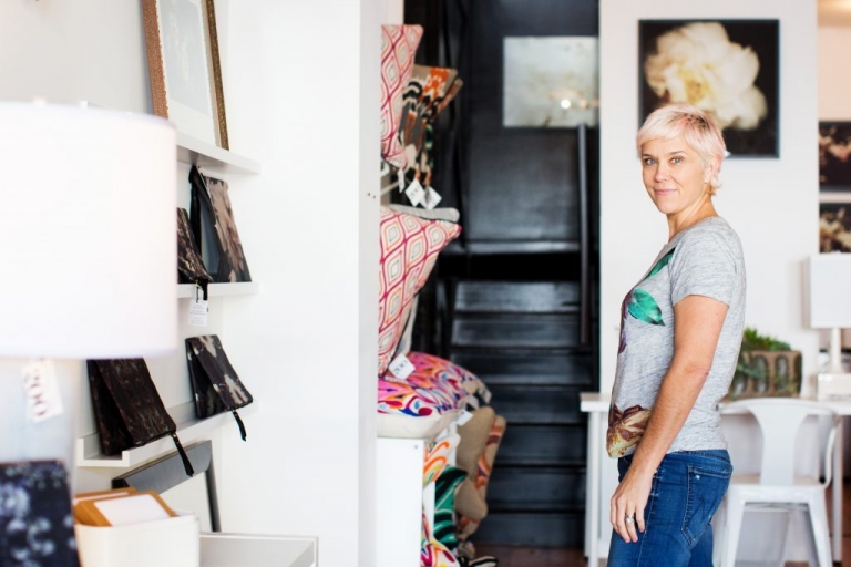 Ashley Woodson Bailey posing for photos amongst her floral prints