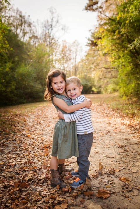 brother and sister hugging during their fall family photos