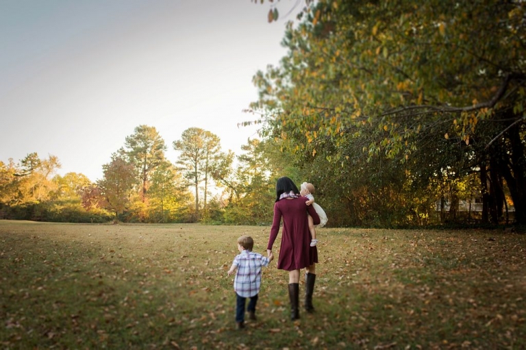 Mother walking with two small children 