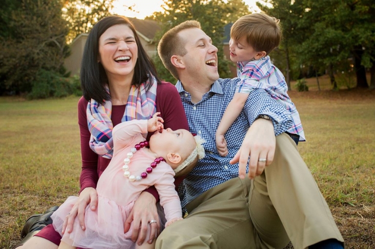 mom and dad laughing at their silly boy