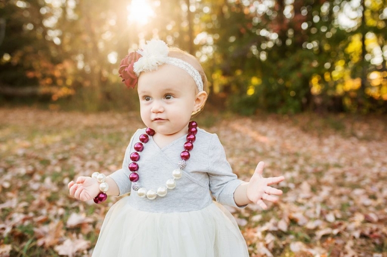 precious little one year old posing for her first year portraits