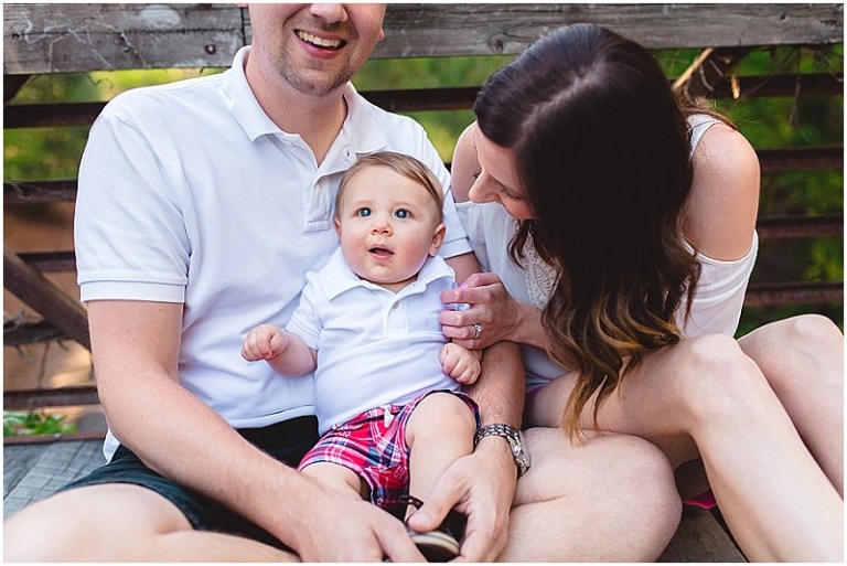baby boy posing with mom and dad for family photos