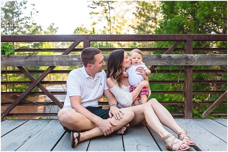 mom kissing baby boy on the cheek
