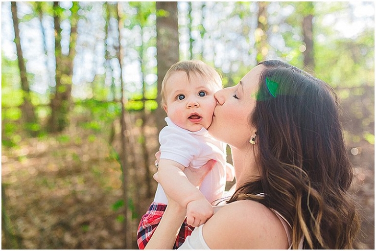 mom kissing baby on the cheek