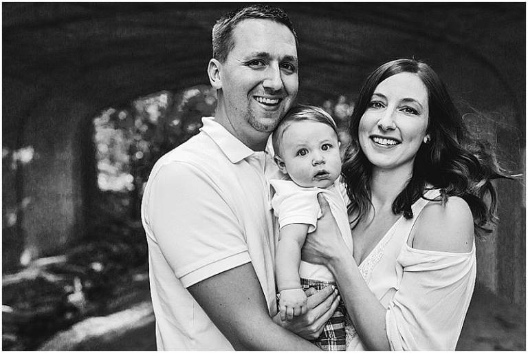 black and white photo of mom, dad, and baby