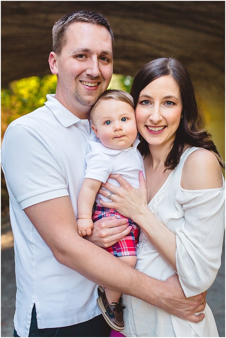 family of three posing for their outdoor family photo