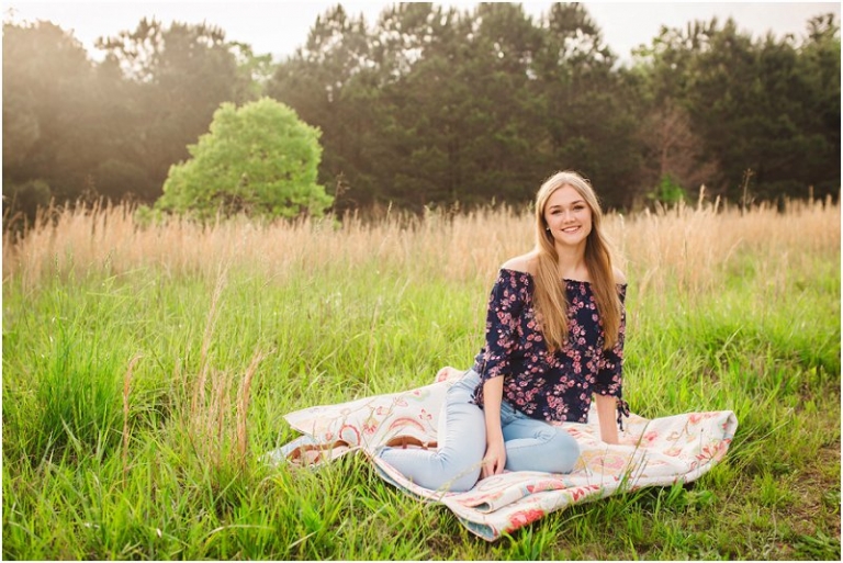 Beautiful girl sitting on a blanket