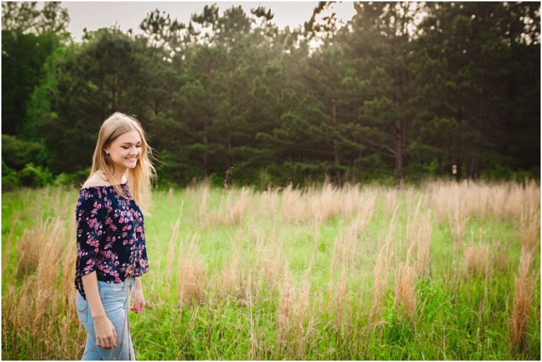 Senior photos taken in a field of tall grass