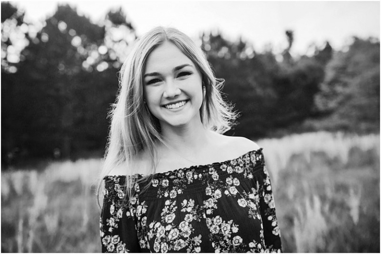 senior photos in a tall grass field