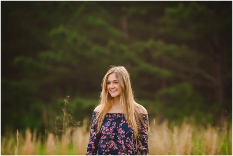 senior photos in a tall grass field