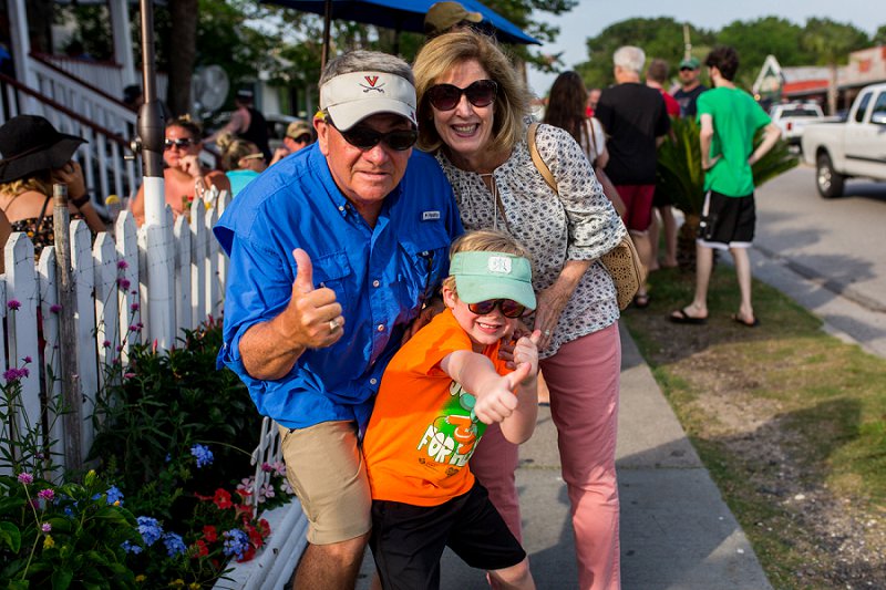 Family photographer Grandparents and grandson giving thumbs up after dinner at Poe's