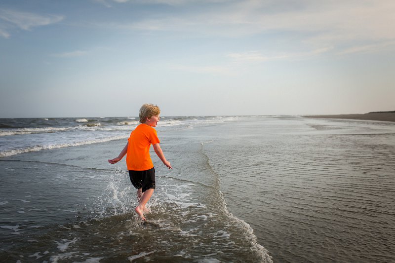Wild Dunes-Isle of Palms Little boy splashing in the ocean water