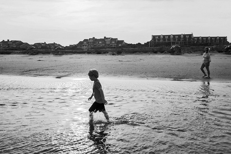 Wild Dunes-Isle of Palms little boy splashing in the ocean at sunset