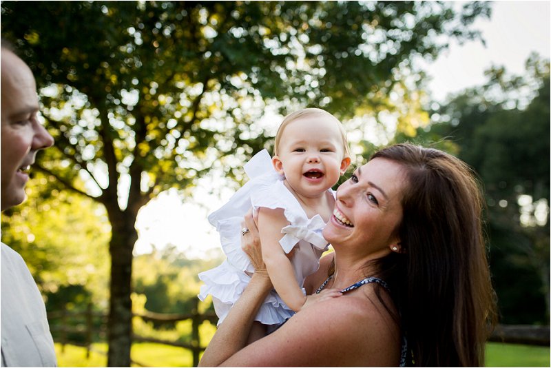 happy mom and baby smiling at daddy