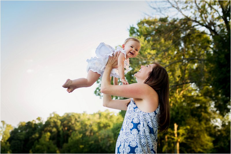 baby girl flying in her mom's arms