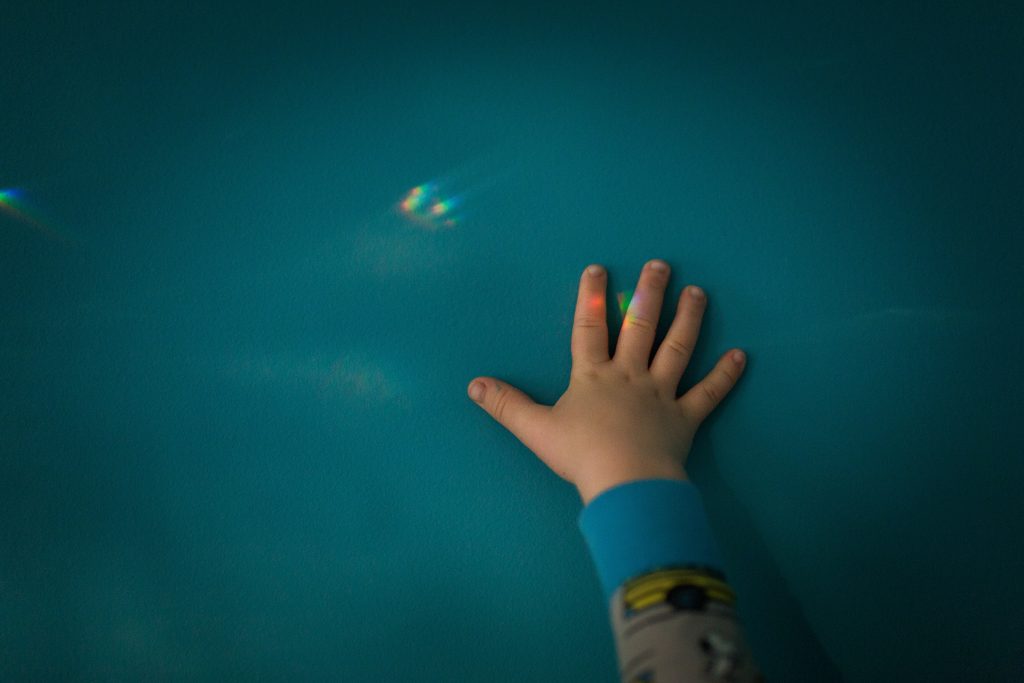 atlanta child lifestyle photographer tiny hand touching a rainbow