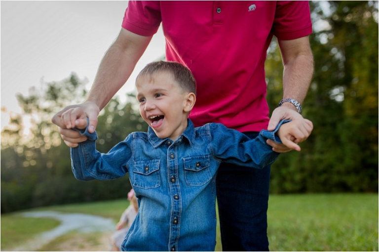 little boy holding hands with his daddy