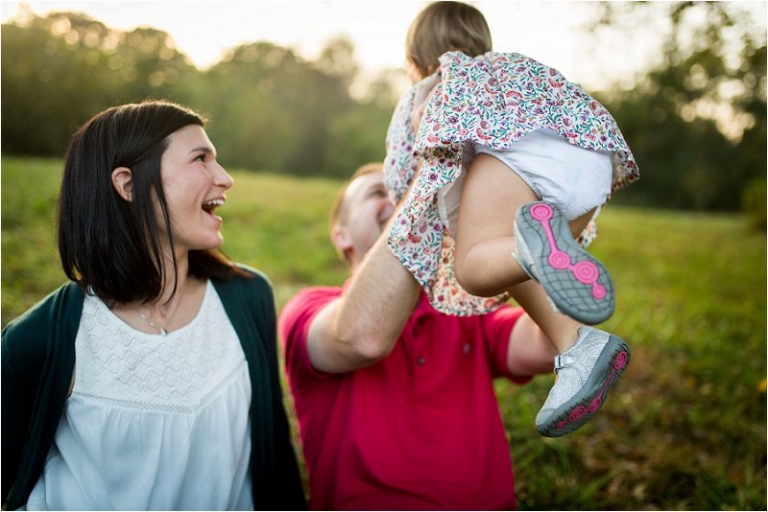 daddy holding up his daughter