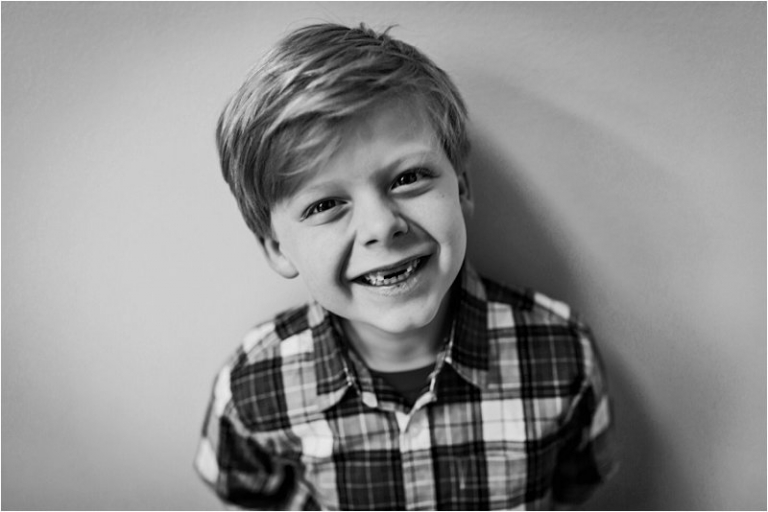 black and white photo of little boy who lost his two front teeth