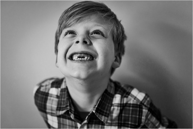 black and white portrait of a little boy who lost his two front teeth