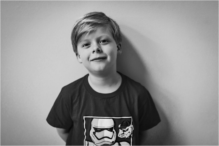 black and white photo of little boy wearing his storm trooper - UGA bulldog t-shirt