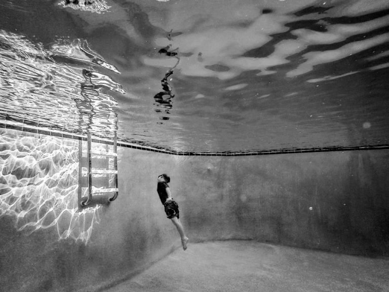 underwater photograph of little boy swimming