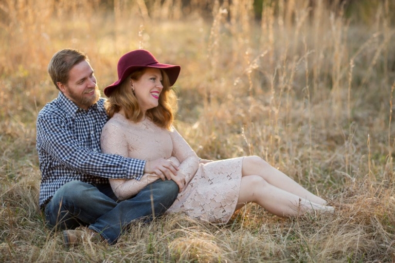 husband and wife smiling off into the distance