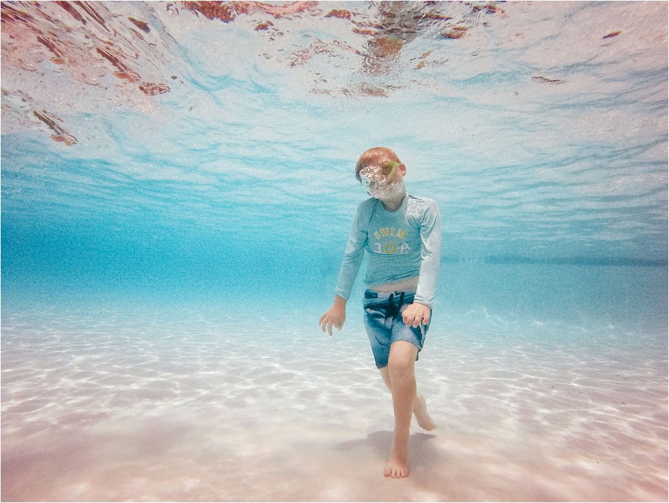 underwater photographs of boy swimming