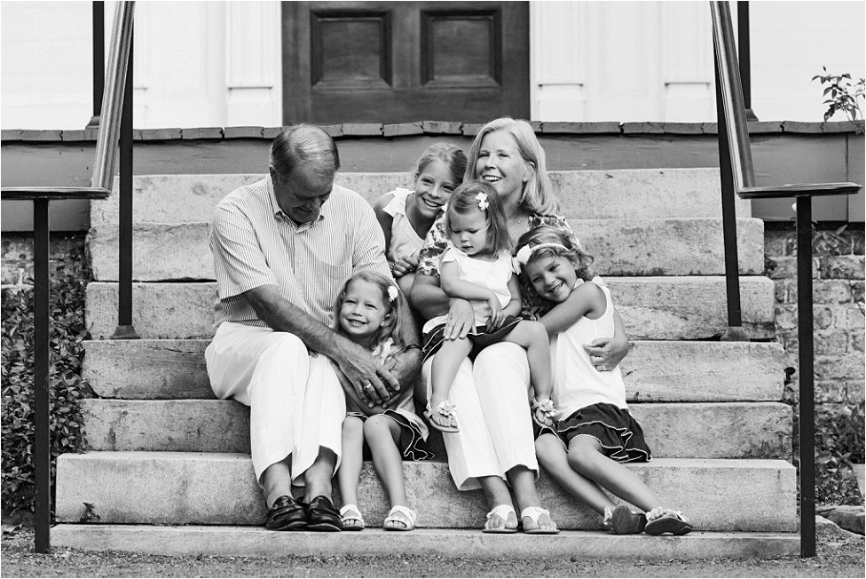 black and white portrait of grandparents laughing with their grandchildren