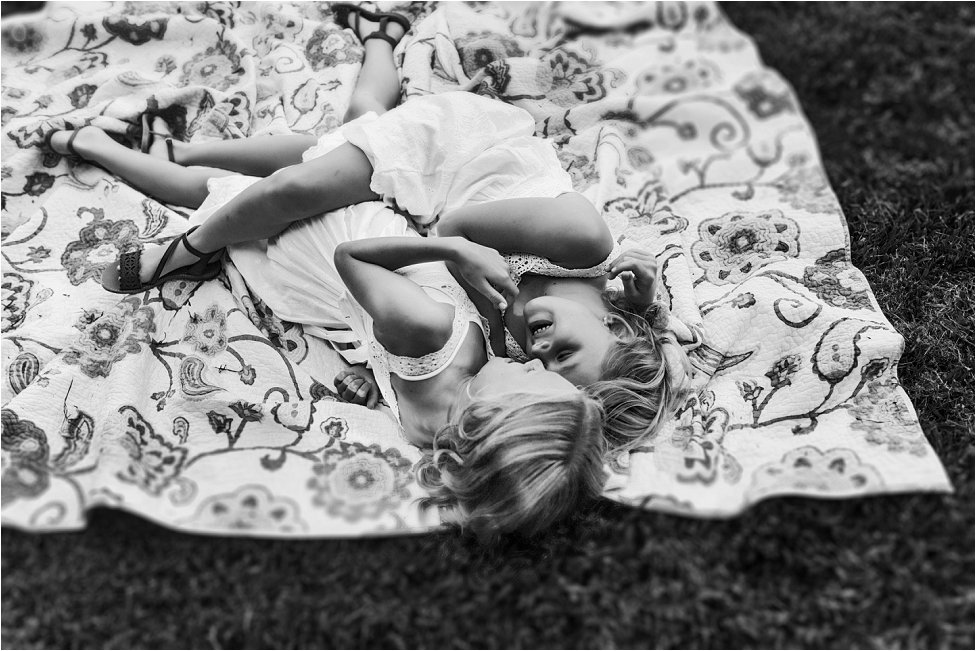 Outdoor Family Photography in Marietta Monochrome image of sisters snuggling