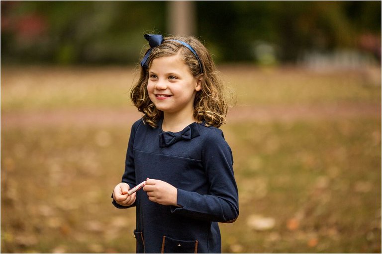 little girl holding a pack of Smarties