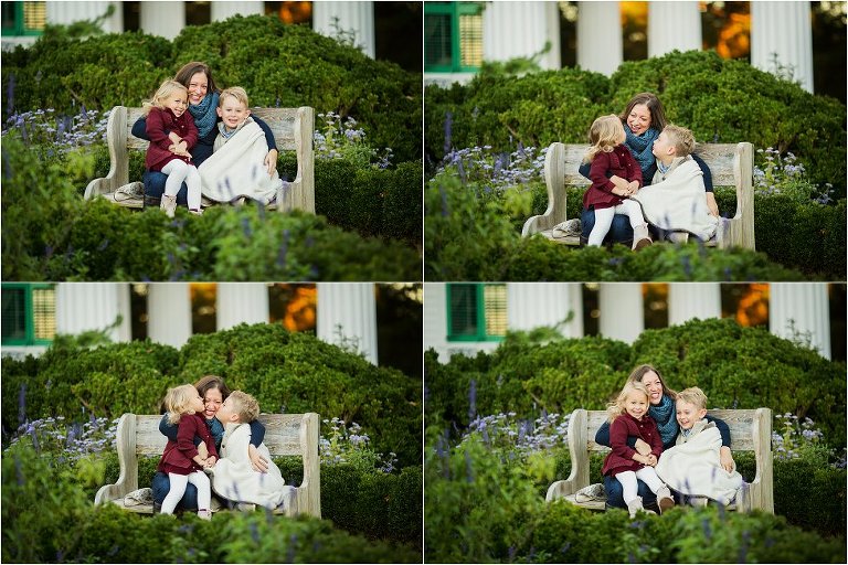 mom and kids snuggling on a bench on a garden