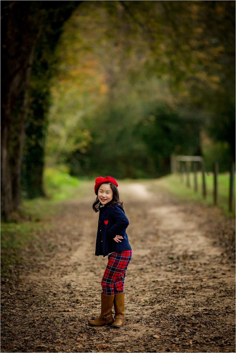 sassy little girl in beautiful fall forest scene