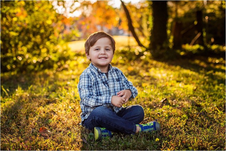 Little boy sitting and basking in the golden light
