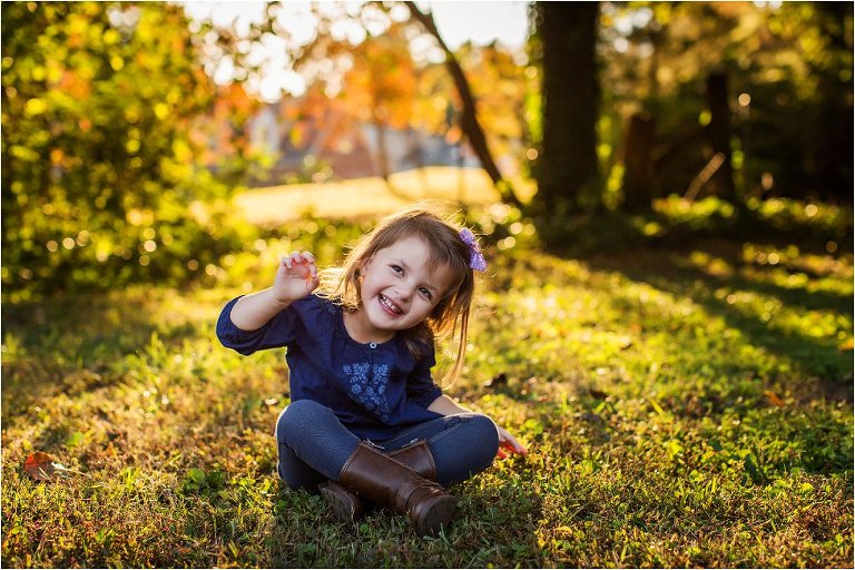 Little girl sitting and basking in the golden light