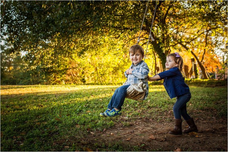 Twin sister swinging her brother