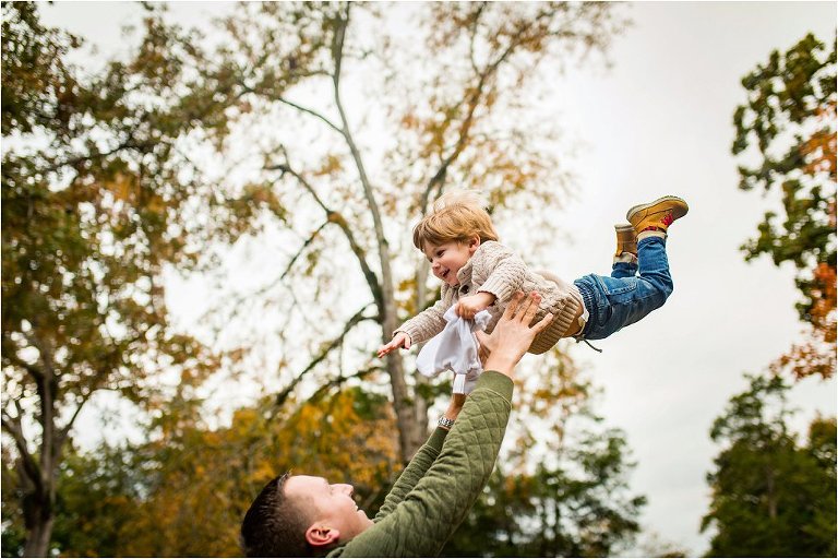 Little boy flying high in the air