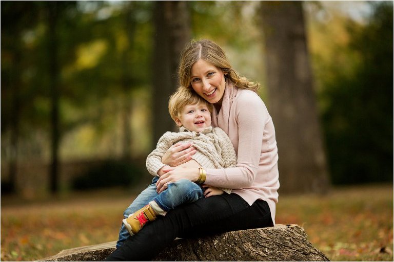 mom snuggling her little boy in her arms.