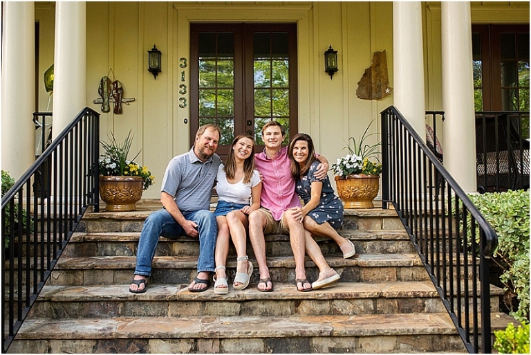Parents sitting on their front stone steps with their college age daughter and son, posing for a family portrait as part of the Front Porch Project, Atlanta, Georgia.