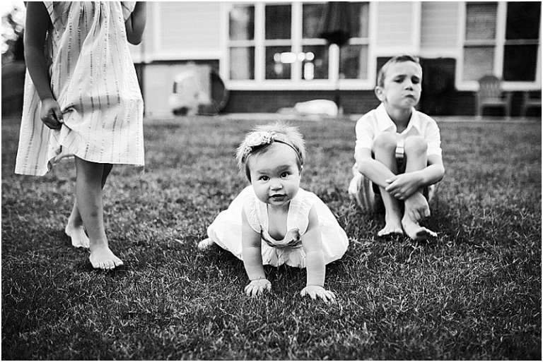 black and white image of three brothers and sisters in their backyard in Marietta.