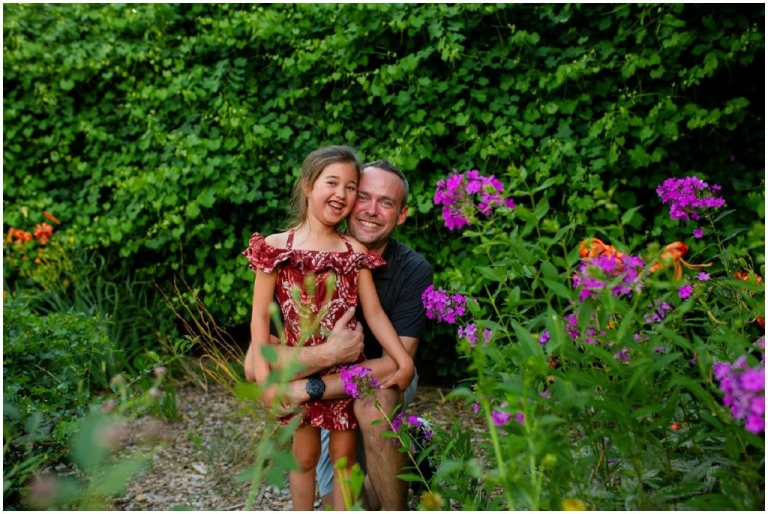 Father snuggling his smiling daughter as they pose for a quick photo.